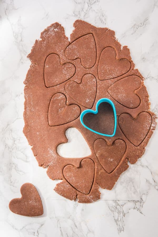 rolled chocolate heart cookie dough with heart cutter.