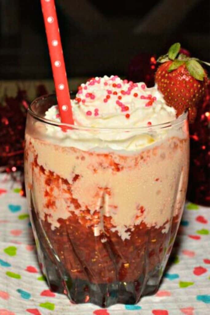 strawberry mudslide in short glass topped with cream.