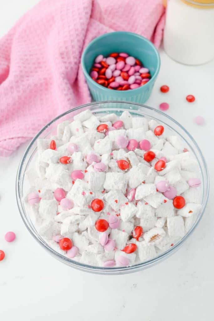 white and pink valentines muddy buddies in a bowl.