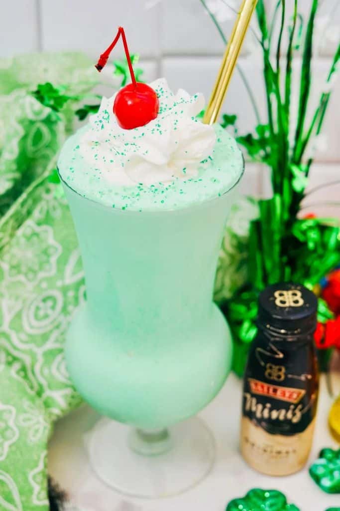 green shamrock shake with whipped cream and cherry.