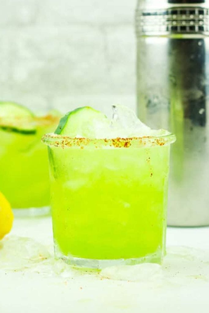 bright green cucumber mocktail in short glass.
