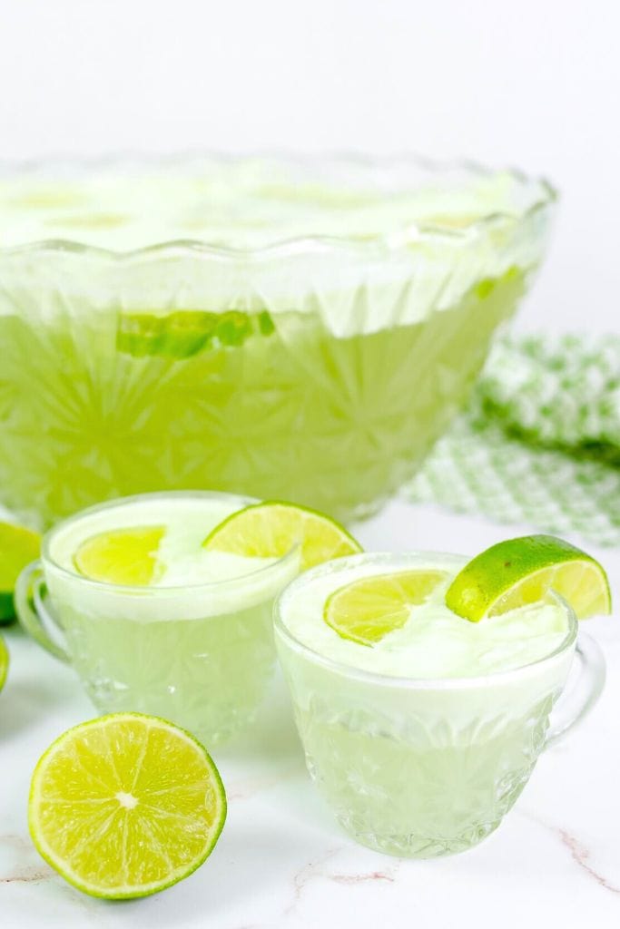 alcoholic lemon sherbet punch in bowl and glasses.