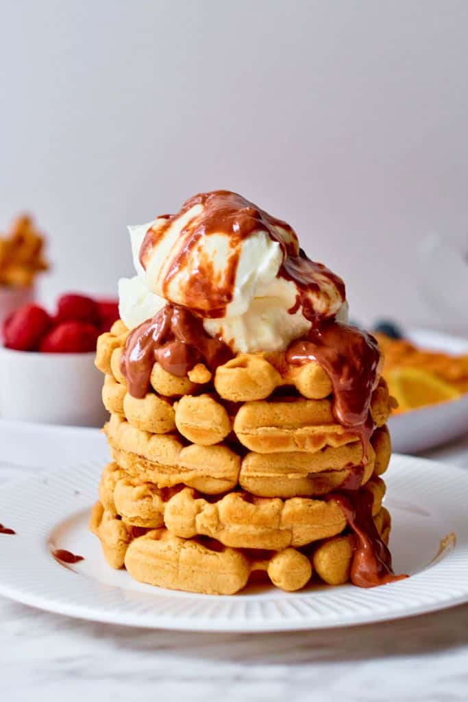 stack of cold brew waffles with chocolate sauce.