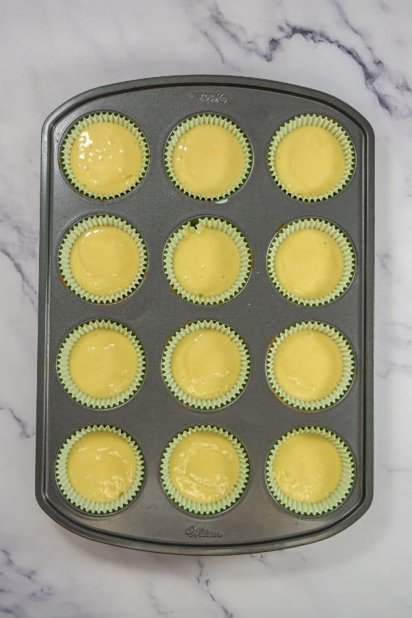 cupcakes mixture in liners in tin.