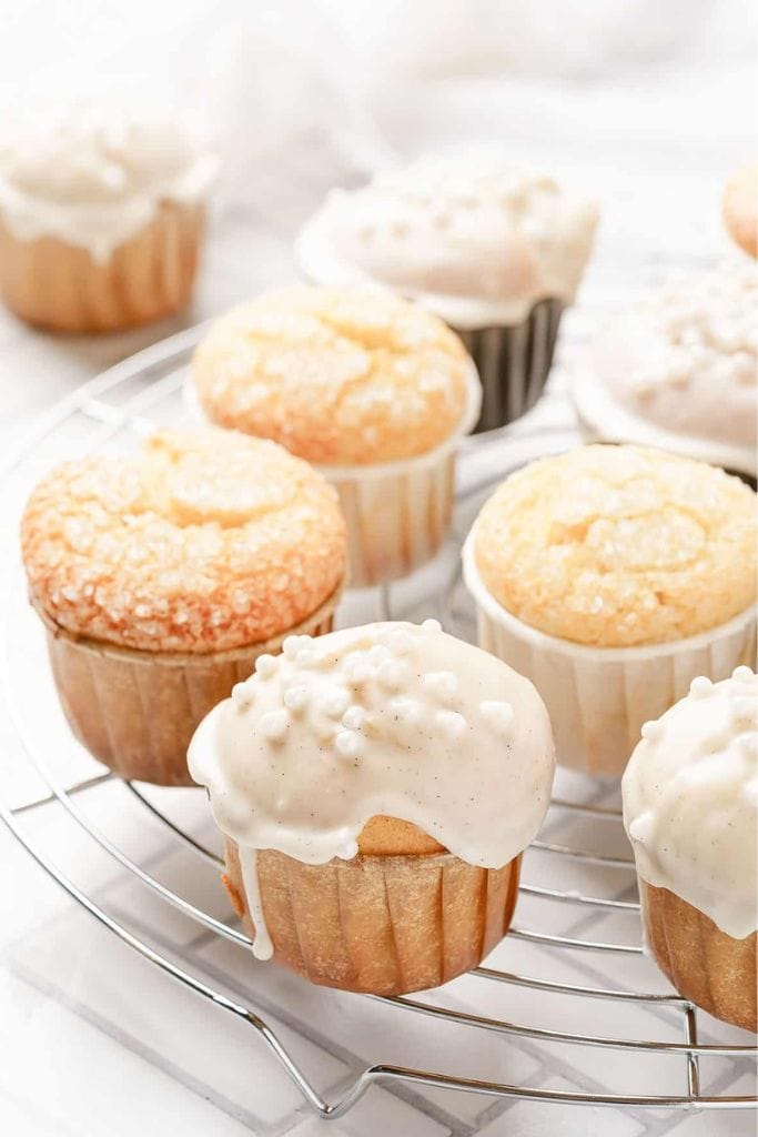 iced vanilla muffins in wire rack.