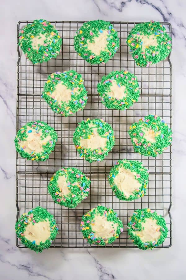 frosted cupcakes with green easter sprinkles.