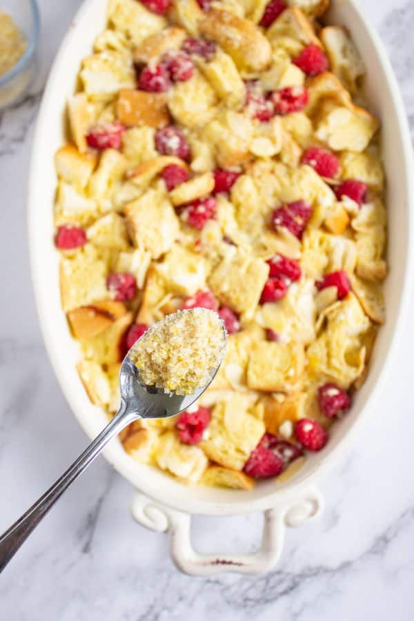 lemon sugar on spoon above dish.