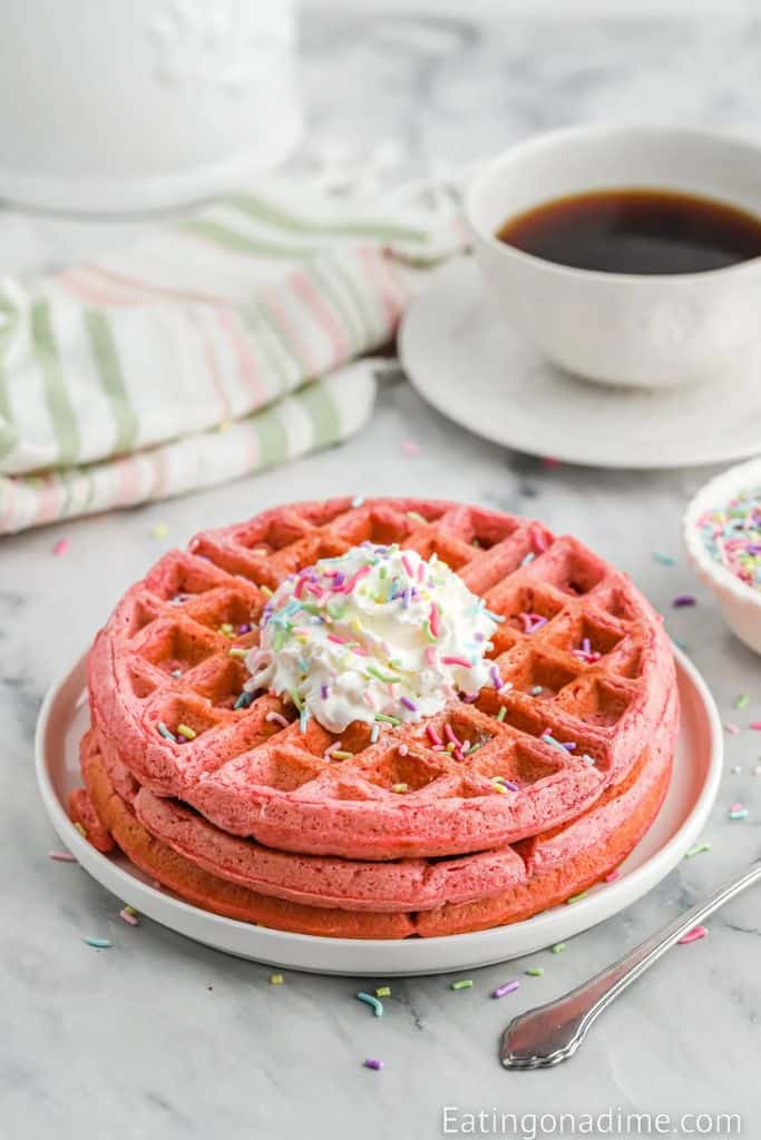 stack of pink waffles with funfetti sprinkles.