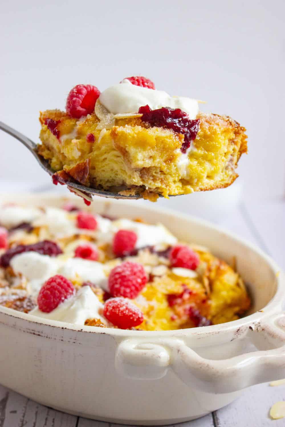 slice of brioche french toast bake above dish.