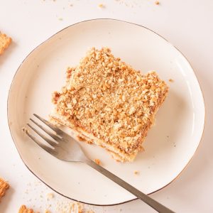 slice of no bake biscuit cake on plate with fork.