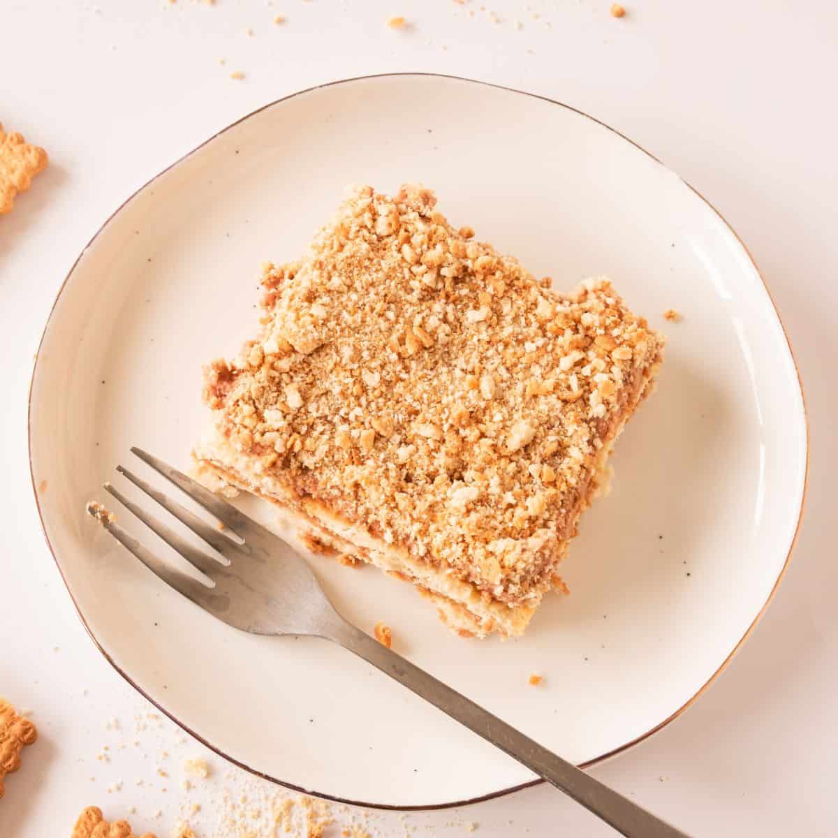 slice of no bake biscuit cake on plate with fork.