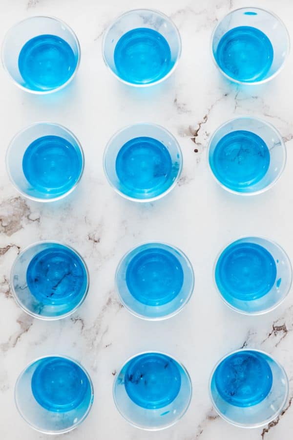 blue jello portioned in to small cups.
