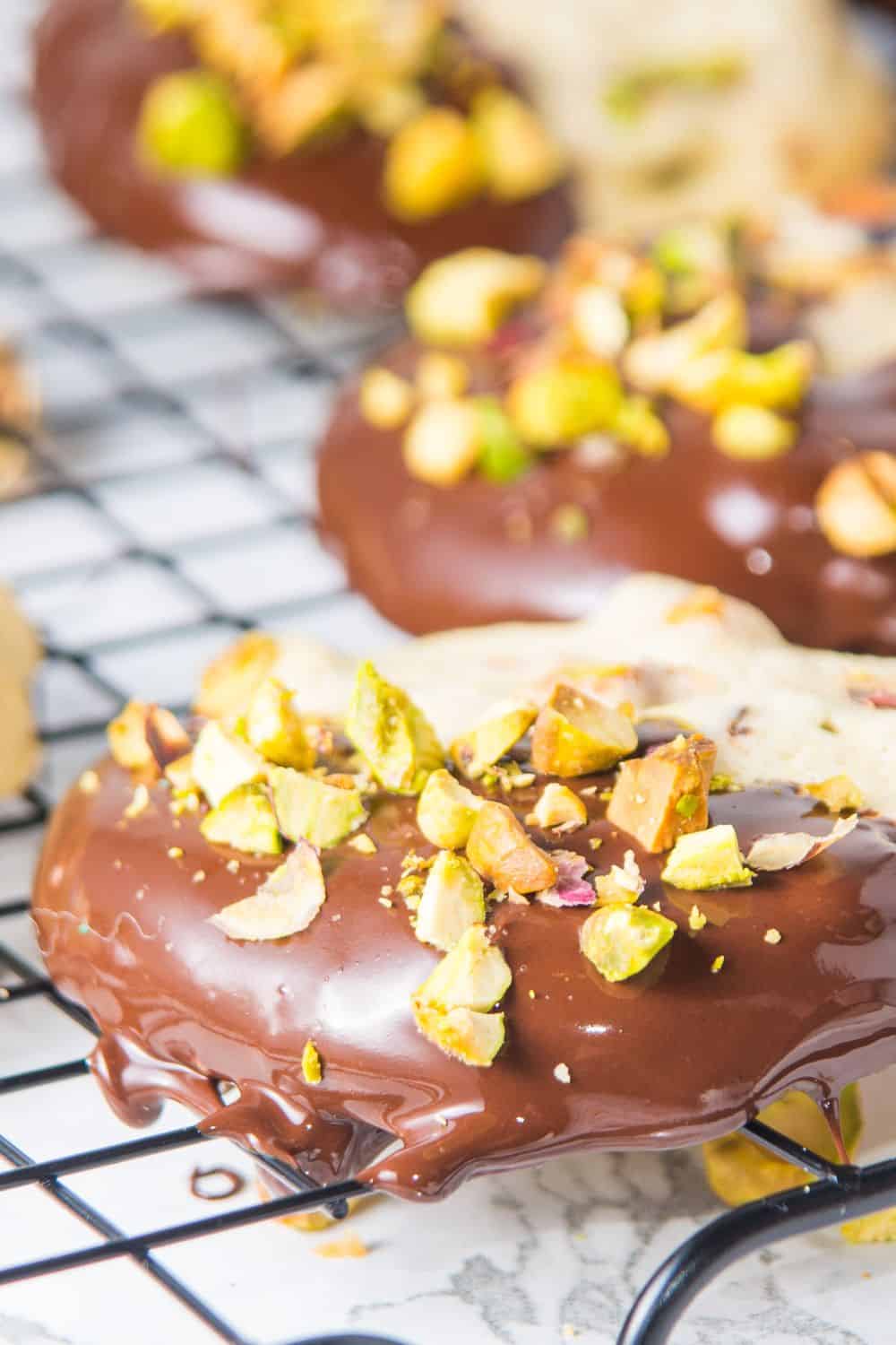 Chocolate covered cookies with pistachios and chocolate frosting.