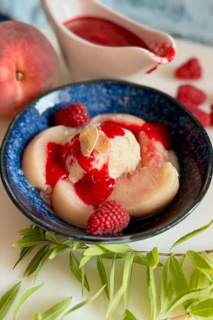 classic peach melba dessert in bowl.