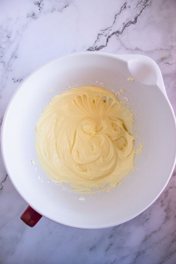 whipped cream cheese frosting mixture in bowl.