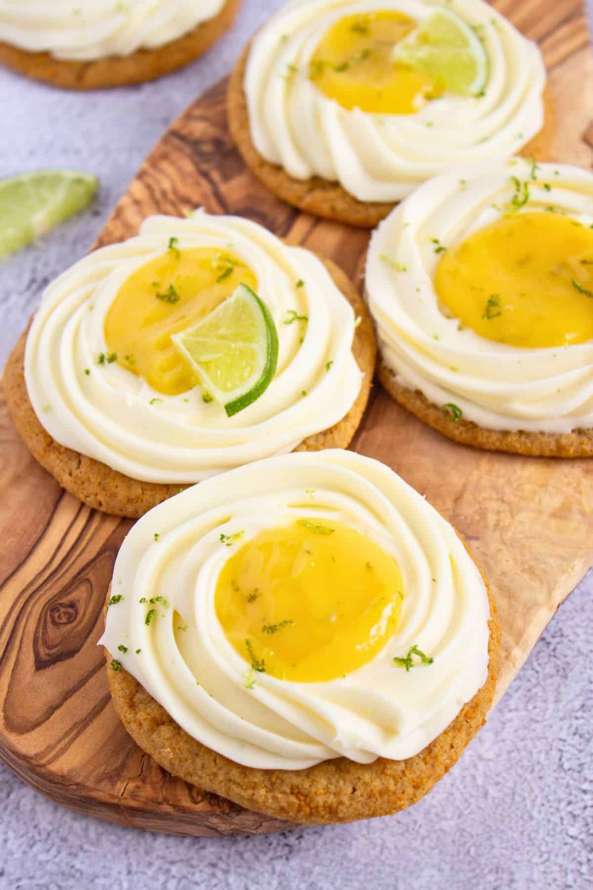 copycat crumbl key lime pie cookies on wooden board.