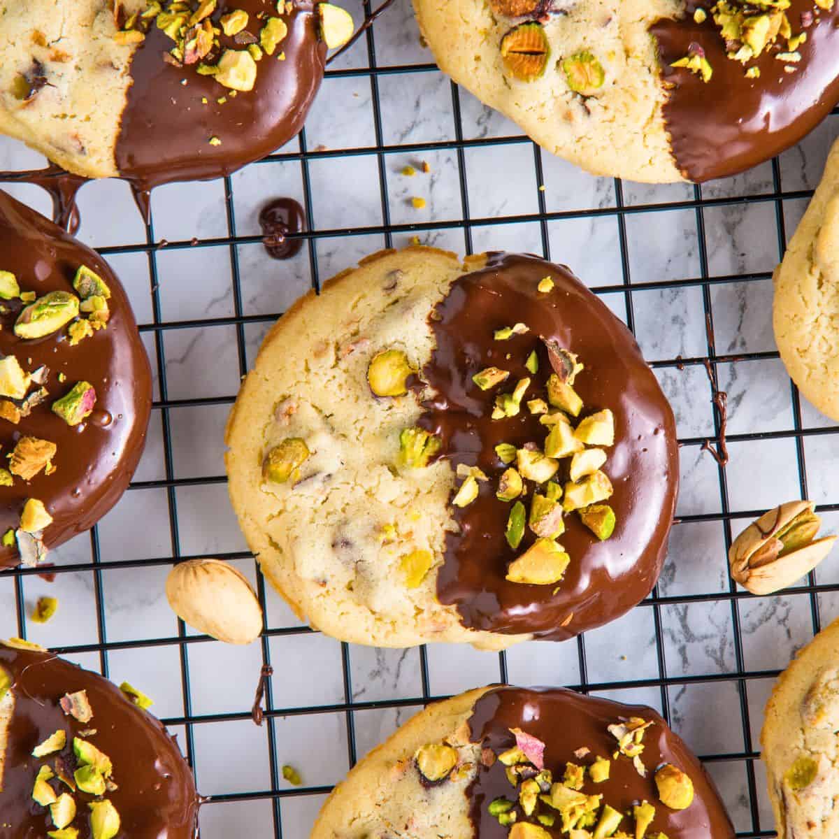 dark chocolate pistachio cookies on wire rack.