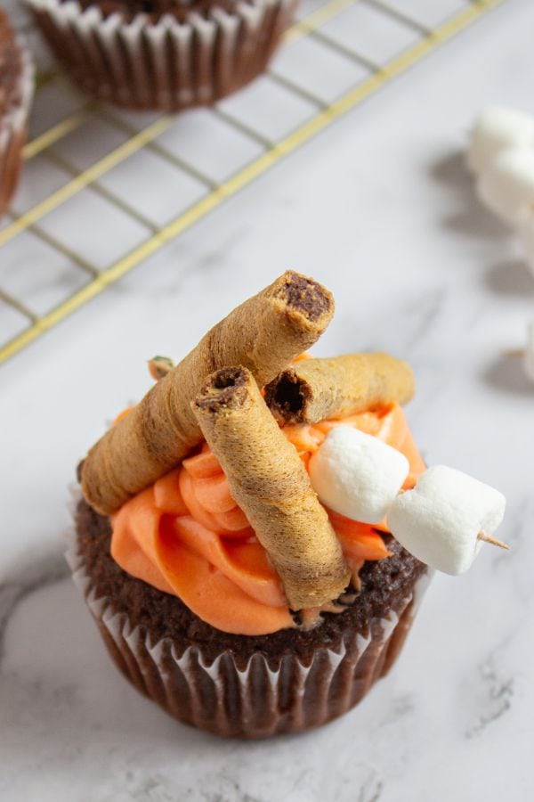 nutella filled cupcakes decorated with wafers and mini marshmallows.