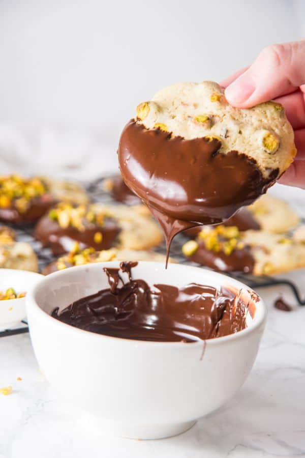 dipping cookies in melted chocolate.