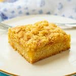 slice of peach crumble bar on plate.