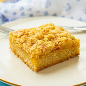 slice of peach crumble bar on plate.