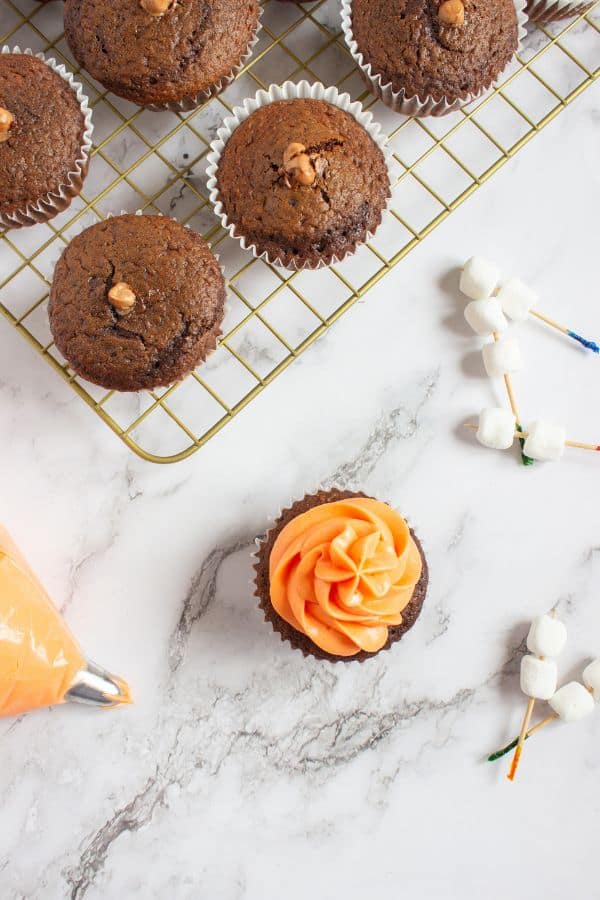 fire colored frosting on top of chocolate filled cupcakes.