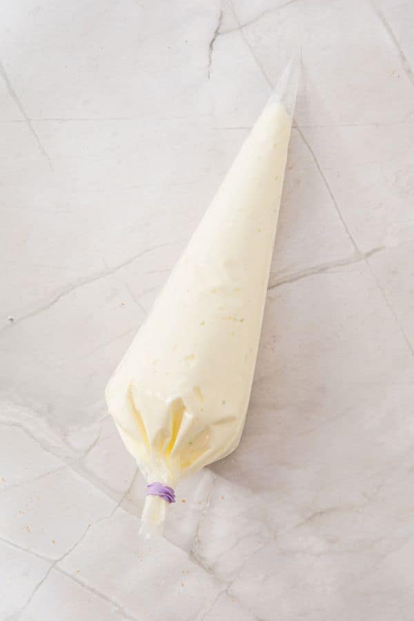 key lime cheesecake filling in piping bag.