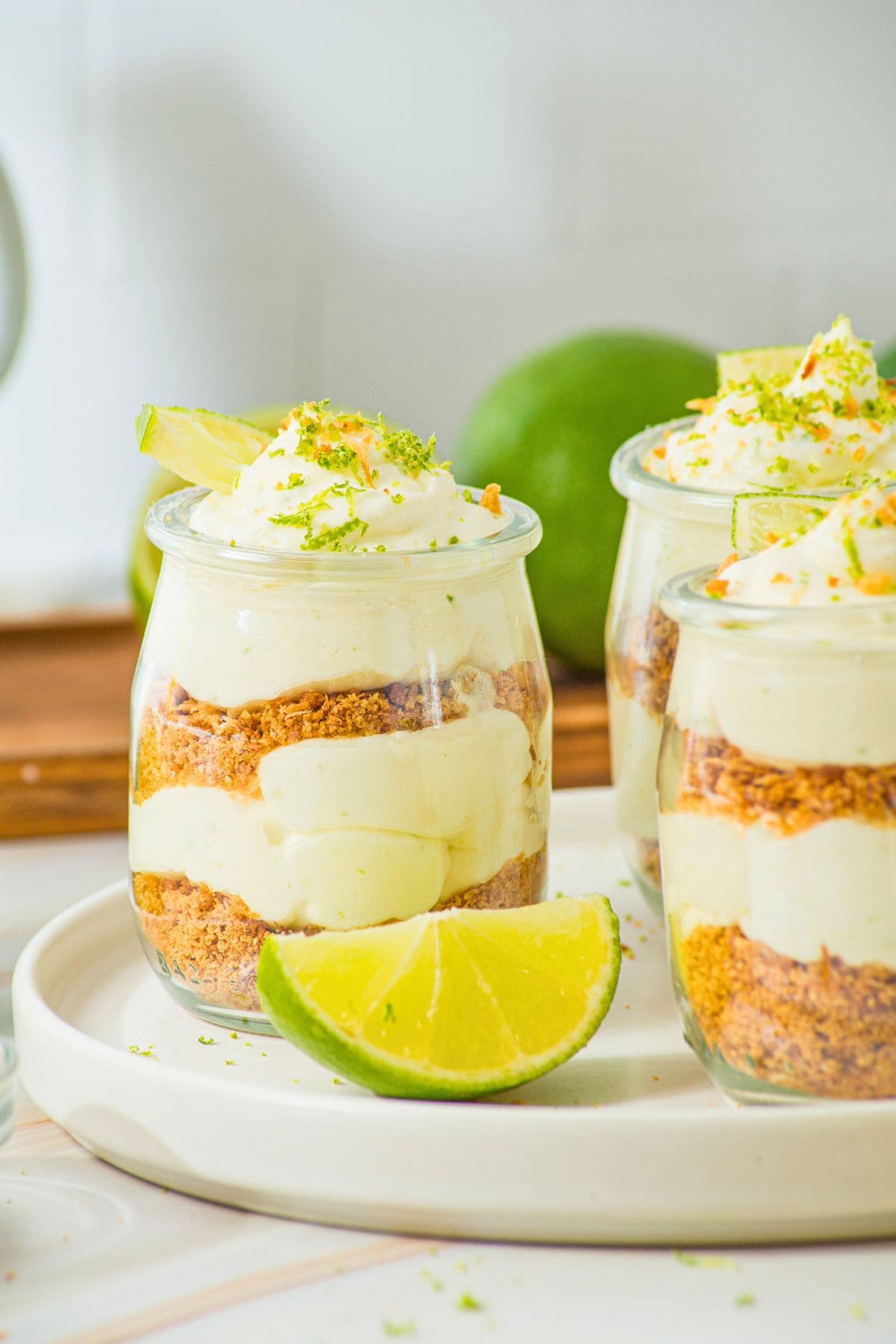 key lime cheesecake mini dessert cups on plate.