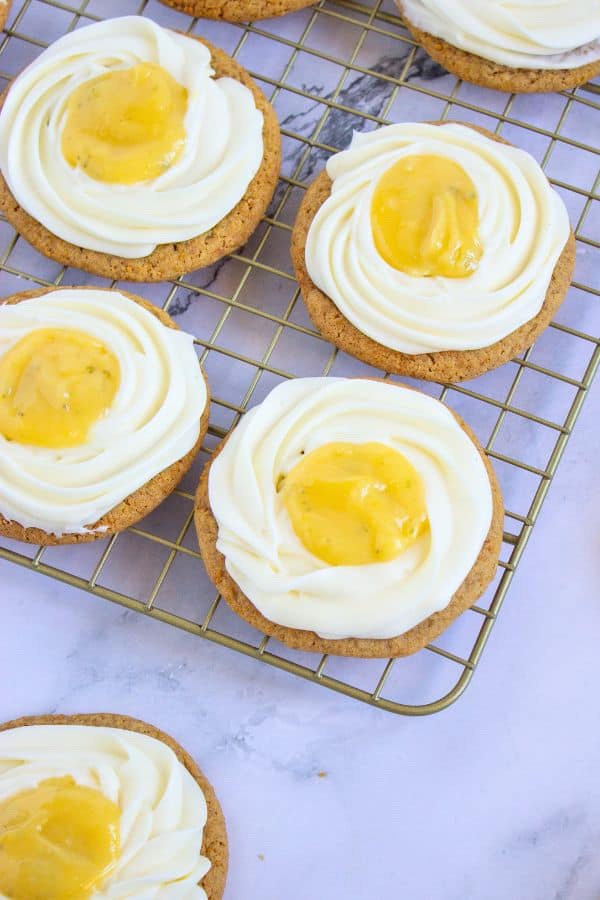 adding key lime curd on frosting for homemade crumbl cookies.