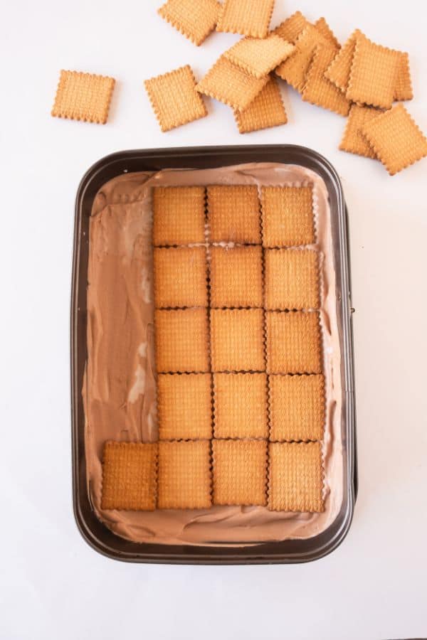 layering biscoff cake with tea biscuits.