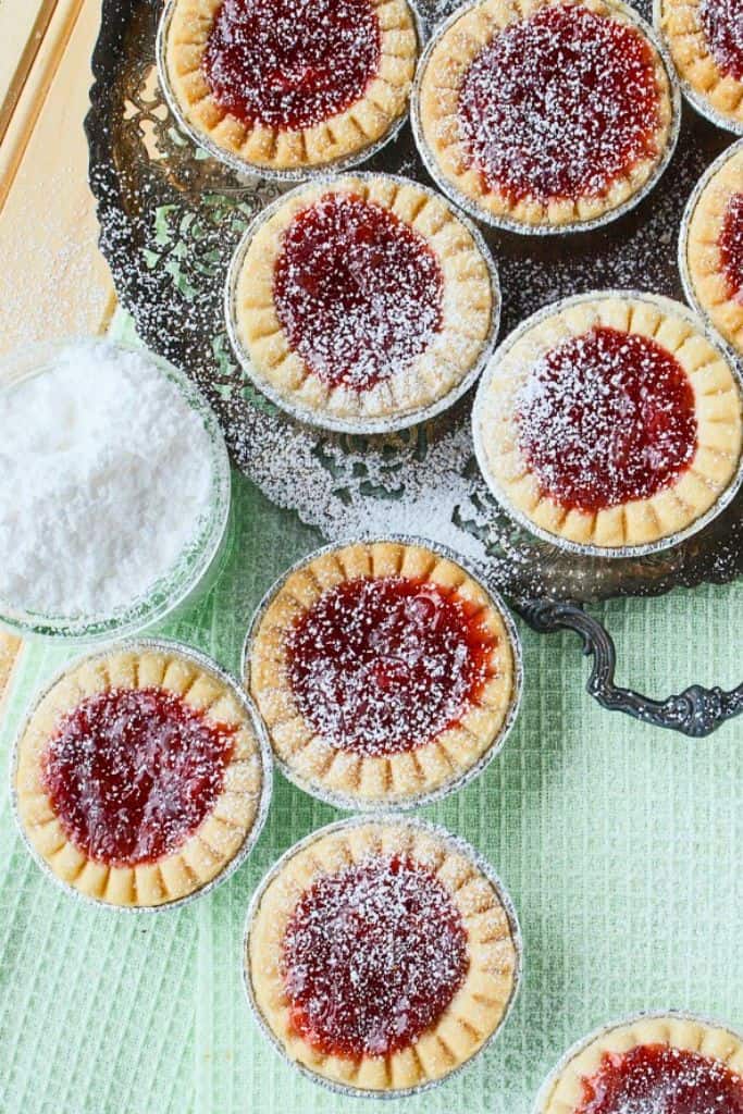 mini rhubarb strawberry tarts dusted with icing sugar.