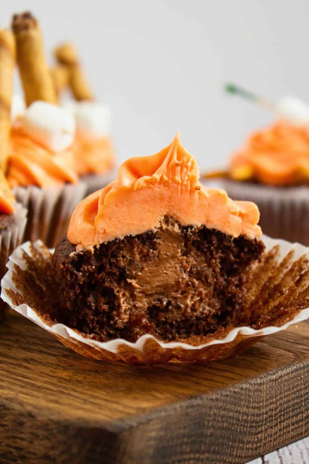 inside view of nutella filled cupcake with orange frosting.