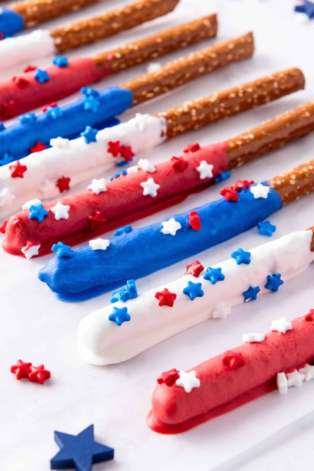 decorated red white and blue pretzel sticks on parchment paper.