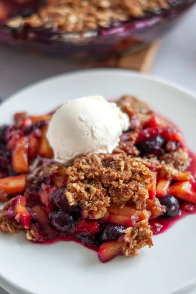 blueberry and peach crisp on plate.
