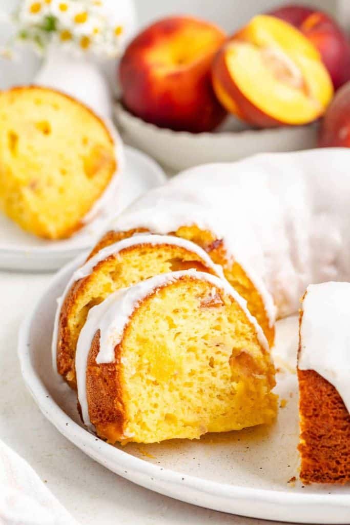 iced peach bundt cake sliced.