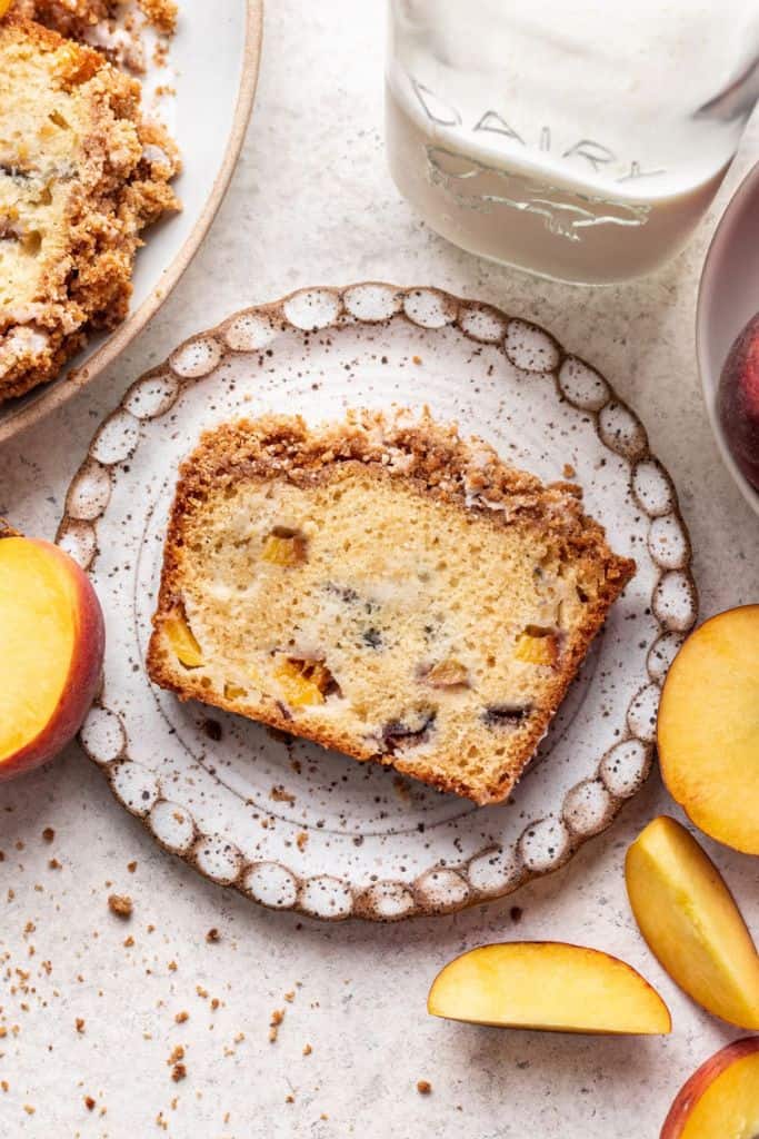 slice of peach loaf cake on plate.