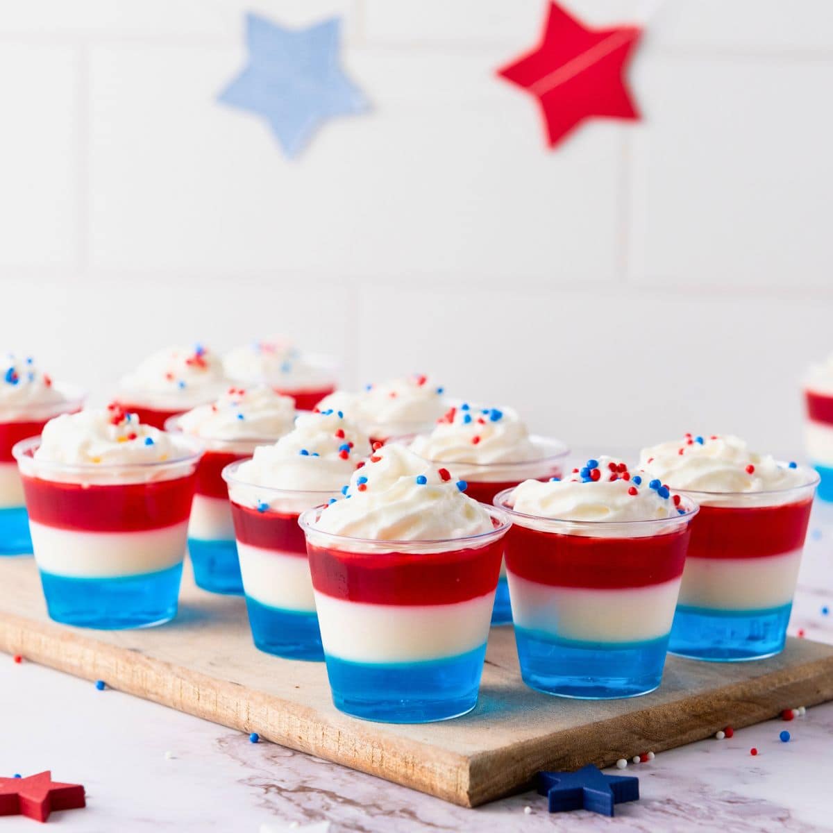 patriotic jello cups on chopping board.