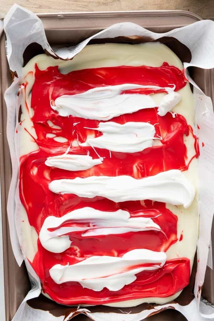 melted red and white candy on bark.