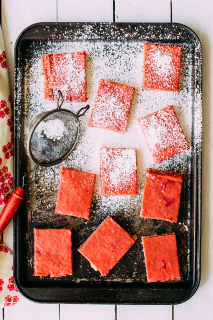 raspberry curd bars on tray.