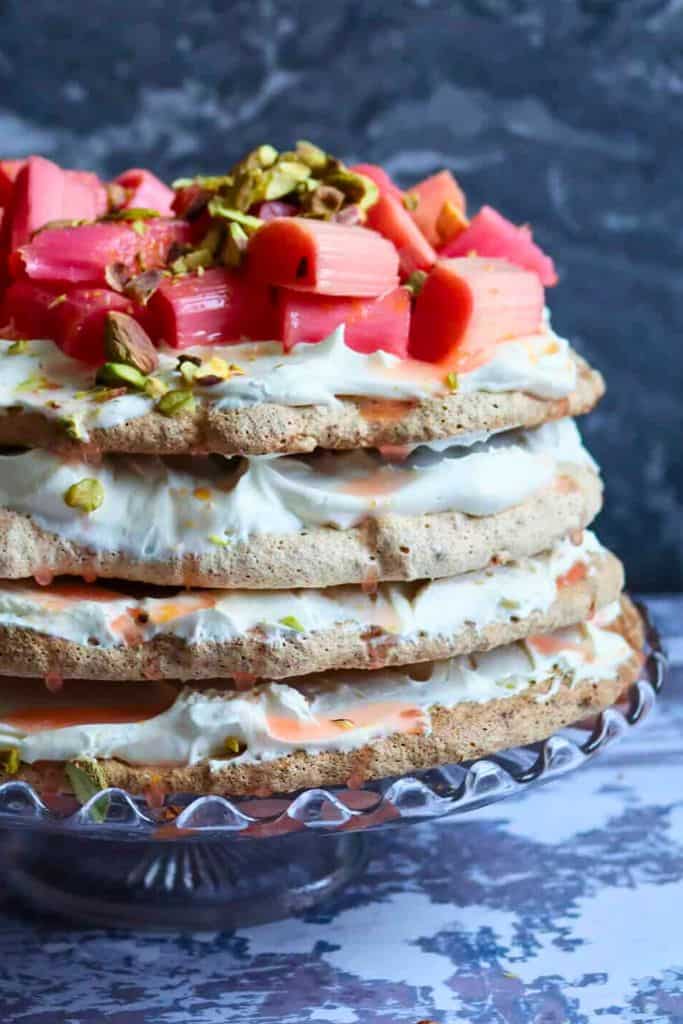 layered pistachio and rhubarb pavlova on platter.
