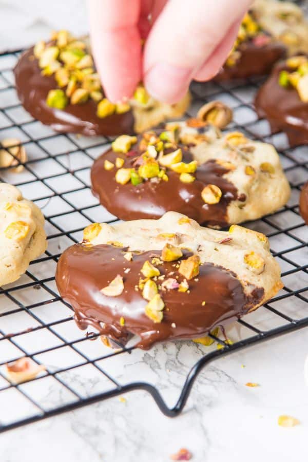 sprinkling cookies with crushed pistachios.