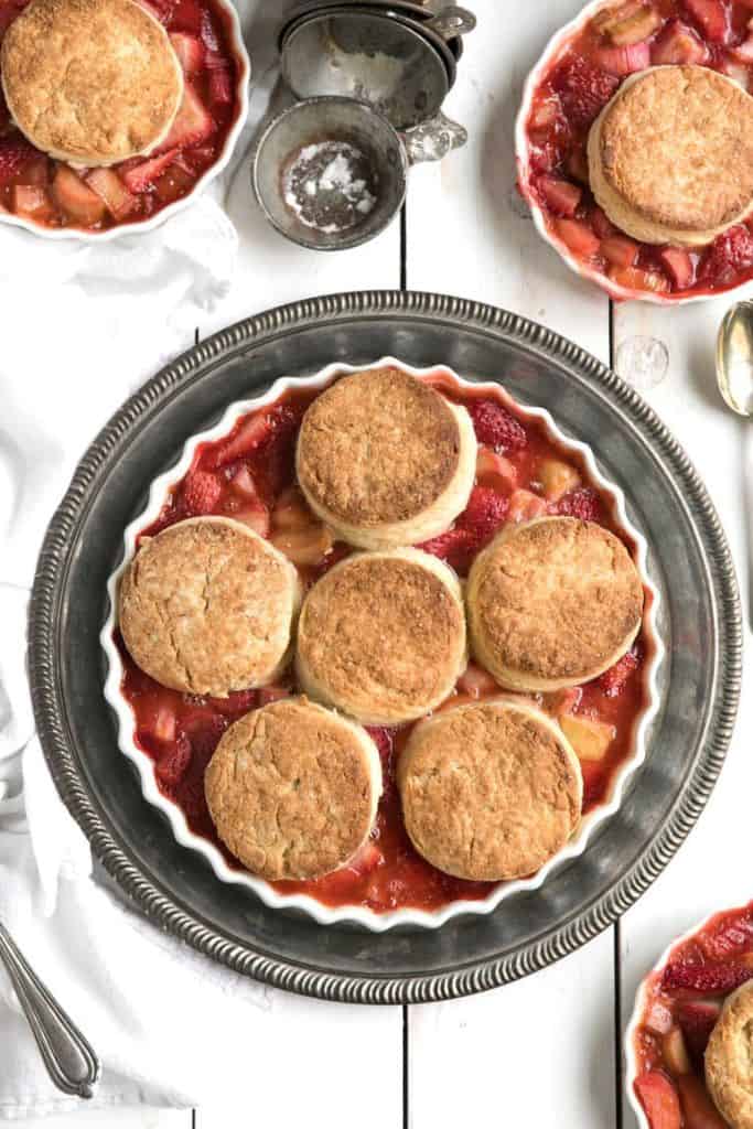 strawberry rhubarb cobbler with honey biscuits in dish.