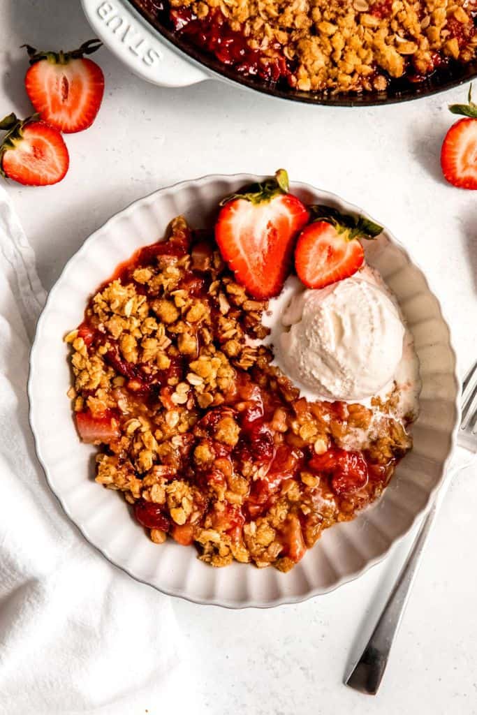 strawberry rhubarb crisp with icecream in bowl.