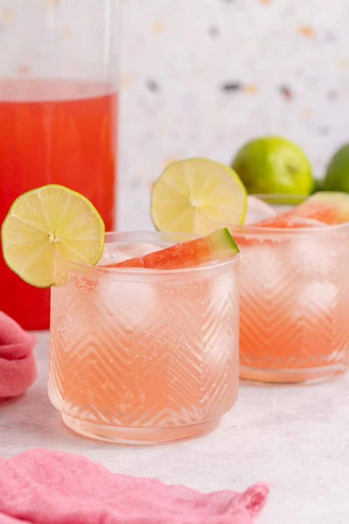 red watermelon sangria in glass with lime.