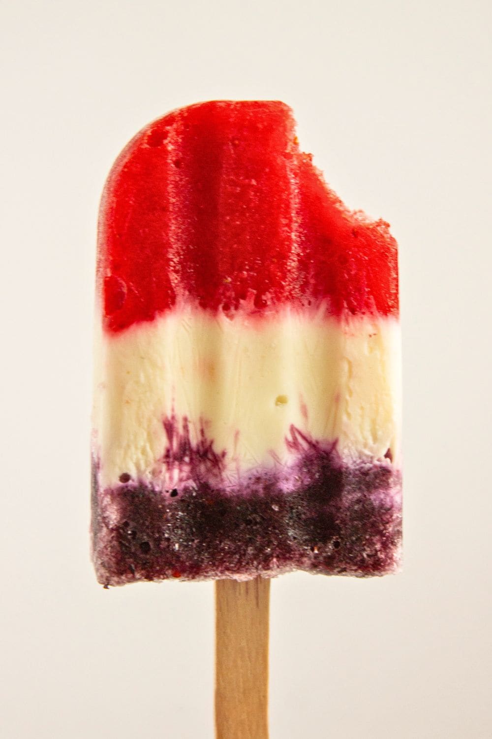frozen fruit yogurt popsicle with bite.