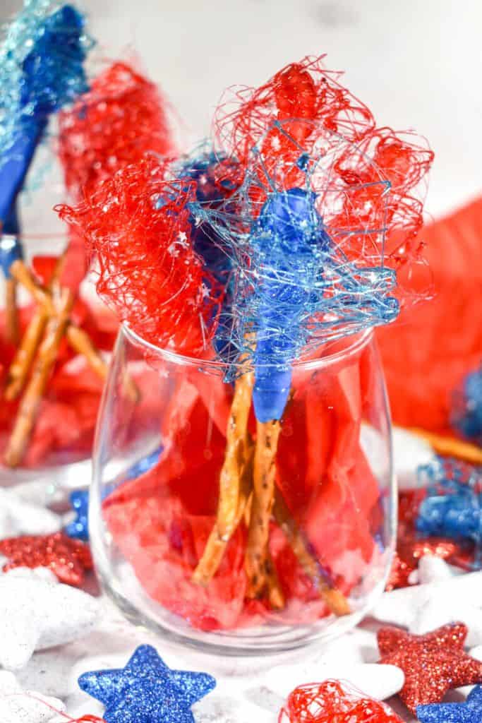 chocolate dipped sugar spun pretzels in glass.