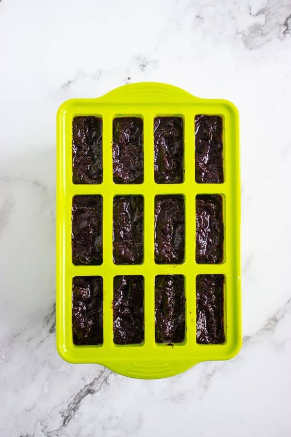 blueberry mixture layered into popsicle mold.