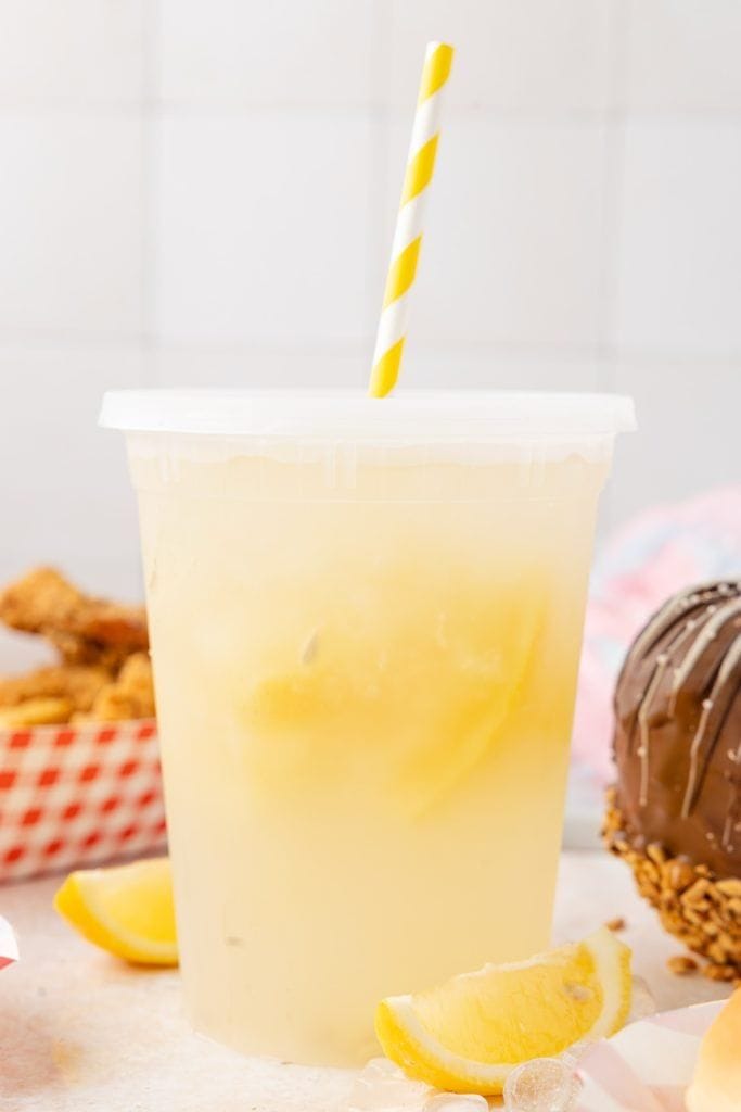 old fashioned lemonade in plastic cup with straw