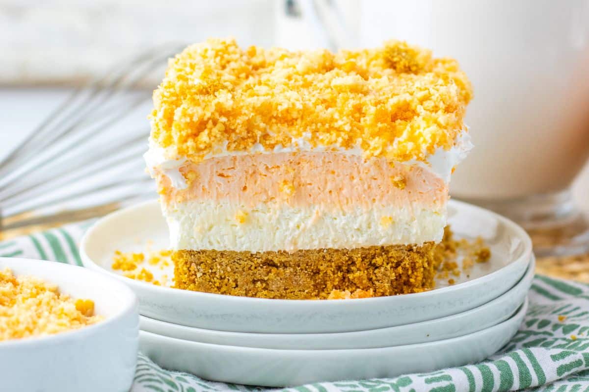 orange cheesecake bar slice on plate.