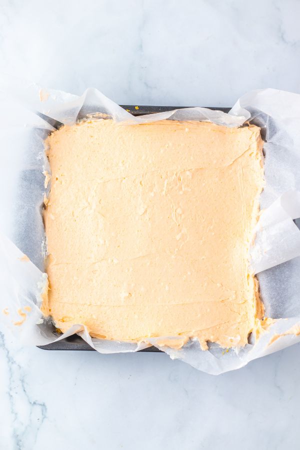 orange jello cream cheese in pan.